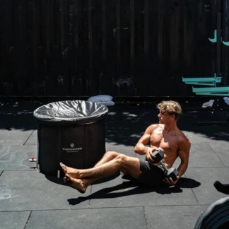 Arktik Pod guy lying down next to pod