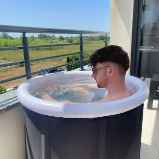 Arktik Pod guy enjoying a cold plunge with green view